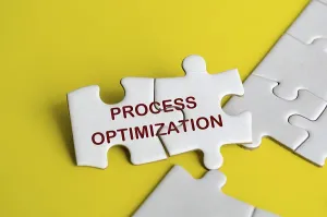 Symbolic Picture Of Progress Drucke: Process optimization text on jigsaw puzzle representing process improvement concept