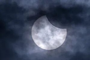 Partial Solar Eclipse Europe Drucke: Partial solar eclipse with clouds in the sky