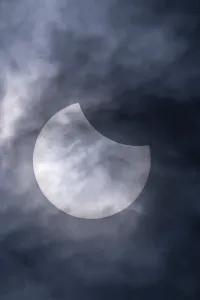 Partial Solar Eclipse Europe Drucke: Partial solar eclipse with clouds in the sky