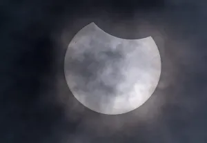 Natural Phenomena Europe Drucke: Partial solar eclipse with clouds in the sky