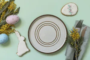 Easter Dinner Table Setting Drucke: Table setting for Easter dinner with easter eggs and mimosa on a pastel background