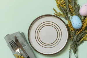 Easter Dinner Table Setting Drucke: Table setting for Easter dinner with easter eggs and mimosa on a pastel background