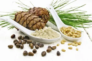 Wooden Board Background Drucke: Cedar flour and peeled nuts in two spoons