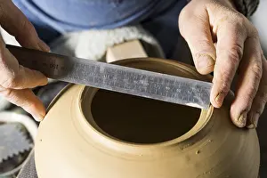 Ceramic Workshop Detail Drucke: Ceramic workshop, hands measuring diameter of opening with ruler