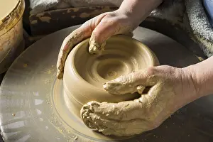 Ceramic Workshop Detail Drucke: Ceramic workshop, hands shape clay on pottery wheel