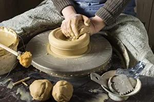 Female Potter Drucke: Ceramic workshop, hands shape clay on pottery wheel