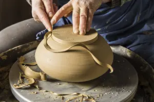 Handcrafted Ceramic Goods Drucke: Ceramic workshop, hands shape bottom of pot on pottery wheel