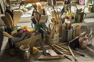 Ceramic Workshop Germany Drucke: Ceramic workshop, tools and brushes in pots on workbench