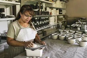 Female Artist Drucke: Ceramist working in pottery studio