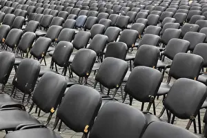 Empty Chair Rows Drucke: Chairs covered with gray plastic stand in rows in a function room