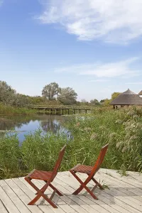 Danube Delta Biosphere Reserve Drucke: Two chairs on viewing platform at the lagoon