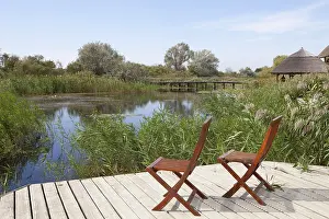 Danube Delta Biosphere Reserve Drucke: Two chairs on viewing platform at the lagoon