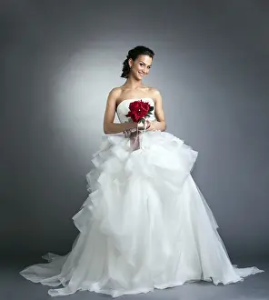 Studio Wedding Photos Drucke: Charming bride with bouquet posing in studio