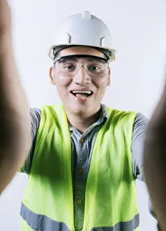 Male Construction Worker Drucke: Cheerful builder engineer taking a selfie isolated