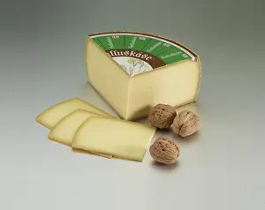 Decorative Food Photography Drucke: Cheese on a light background, decorated with walnuts