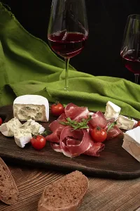 Rustic Wooden Board Still Life Drucke: Cheese and meat appetizer selection