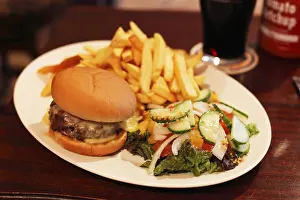 Gastronomy In Europe Drucke: Cheeseburger with chips and salad