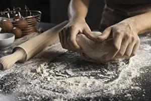 Male Chef In The Kitchen Drucke: Chef kneading dough flour table