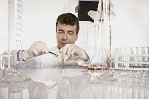 Laboratory Equipment Drucke: Chemist conducting an experiment in a lab