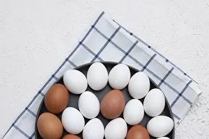 Balanced Diet Ideas Drucke: Chicken eggs on a checked kitchen towel on a light table