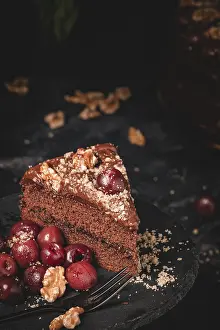Studio Shot Of Cake Drucke: Chocolate cake with nuts and cherries