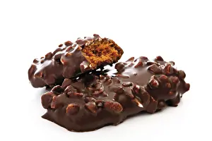 Baked Goods Studio Shot Drucke: Chocolate and nut covered biscuit