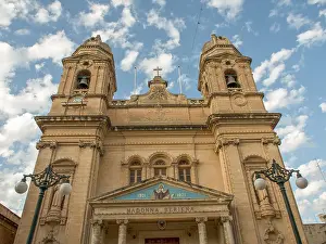 European Sacred Building Design Drucke: Church facade with decorative elements and domes under cloudy sky