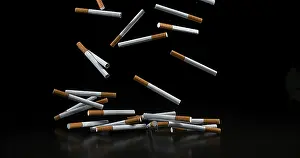 Addictive Drug Symbolism Drucke: Cigarettes Falling against Black Background