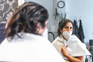 COVID 19 Safety Measures Drucke: Client with face mask looking in the mirror