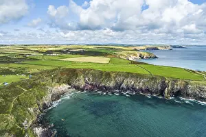 Steep Rocky Cliffs Europe Drucke: Cliffs over Caerfai Beach and Bay from a drone