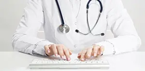 Medical Diagnosis Drucke: Close up doctor typing on computer keyboard