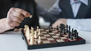 Retirement Hobby Ideas Drucke: Close up elderly playing chess