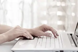 Modern Architecture Concept Drucke: Close up of female hands using modern computer