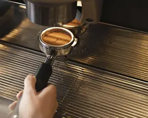 High Quality Food Photography Drucke: Close up hand preparing coffee with machine