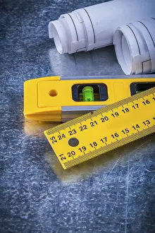 Metallic Background Concept Drucke: Close up image of rolled up blueprints ruler