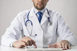 One Person Working At Desk Drucke: Close up of male therapist hands using tablet computer