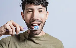 Dental Care Drucke: Close up of man brushing his teeth isolated