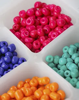 Prismatic Colors Drucke: Close up multi colored beads heap in box