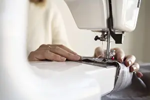 Sewing Machine Details Drucke: Close up person using sewing machine