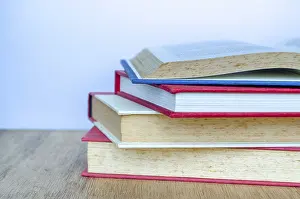 Desk Organization Drucke: Close up of stake of books with customizable space for text