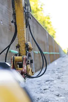 European Building Sites Drucke: Close-up of a construction machine with hoses on a construction wall