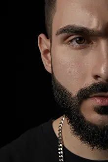 Close Up Portrait Drucke: A close-up dramatic portrait of a young serious guy
