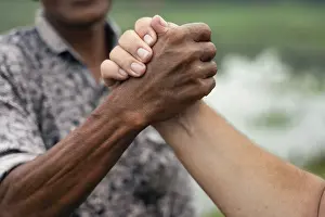 Greenery Landscape Drucke: Close-up of two hands clasped together
