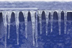 Quebec Province Winter Scene Drucke: Close-up of icicles against a blue plastic background