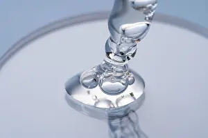 Cosmetic Pipette Drucke: Close-up image capturing the delicate movement of a clear