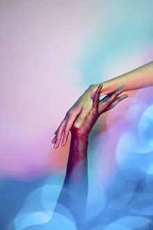 Colorful Background Image Drucke: A close-up image of two multiethnic hands reaching towards each other in a gesture of unity and support