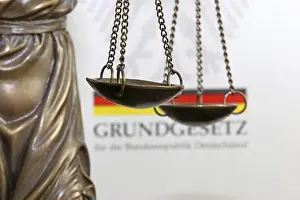 Symbolic Justice Image Drucke: Close-up of a Justitia in front of the German constitution
