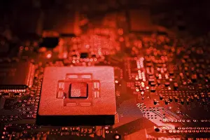 Computer Motherboard Drucke: Close-up of red lighted microchip on electronic computer circuit board
