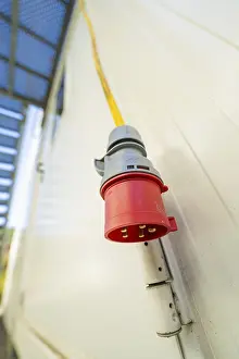 Black Forest Architecture Drucke: Close-up of a red socket on the outside wall of a container building
