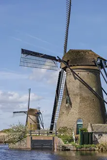 River Landscape Photography Europe Drucke: Close-up of a tall windmill with another windmill in the background